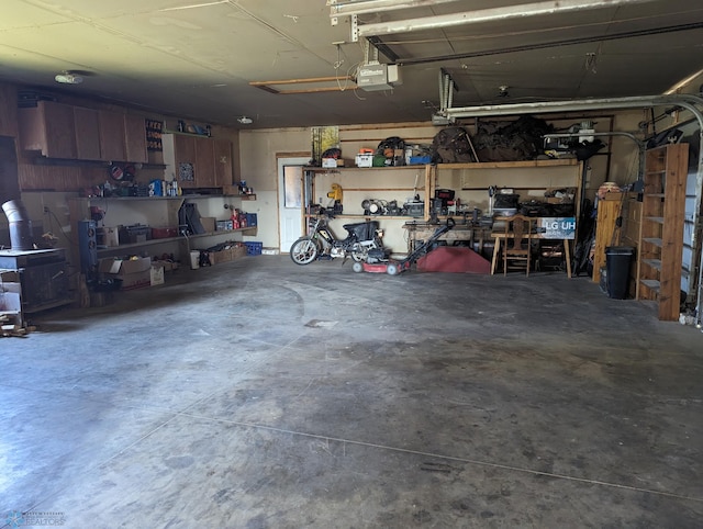 garage with a garage door opener and a workshop area