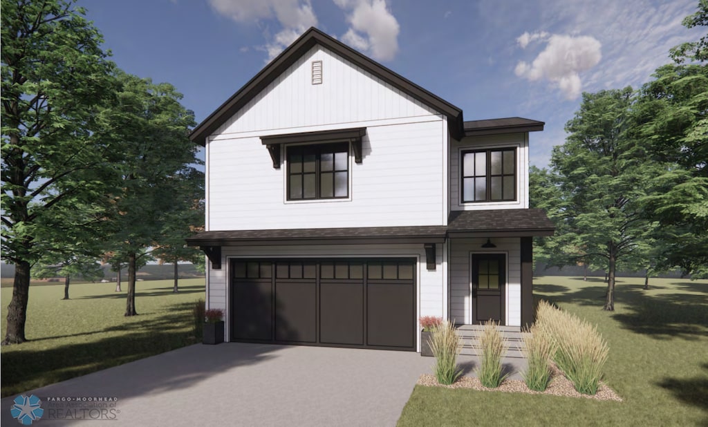 view of front of house featuring a front lawn and a garage