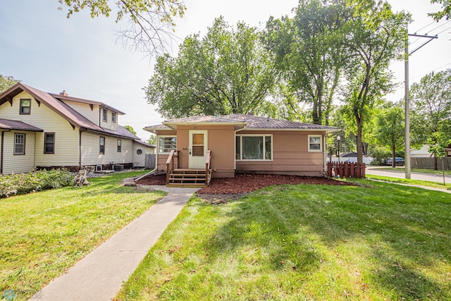 bungalow-style home with a front lawn