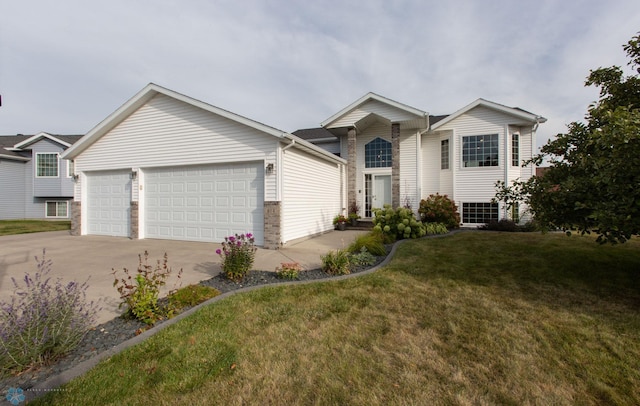 view of front of house with a garage and a front lawn