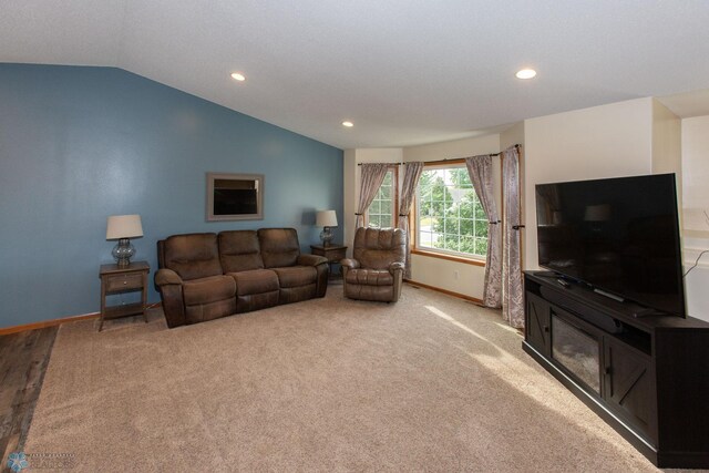 carpeted living room with vaulted ceiling