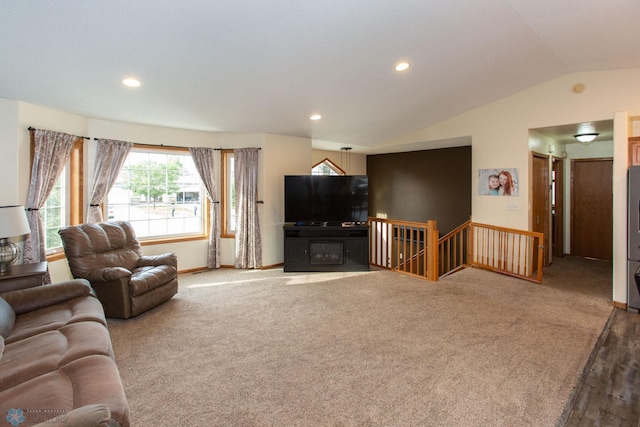 carpeted living room with lofted ceiling