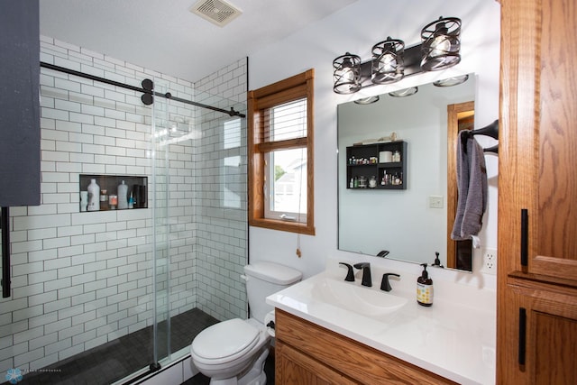 bathroom with vanity, a textured ceiling, toilet, and an enclosed shower