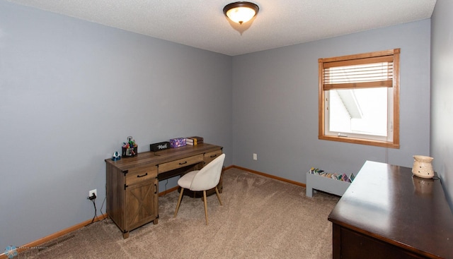 home office featuring a textured ceiling and light carpet