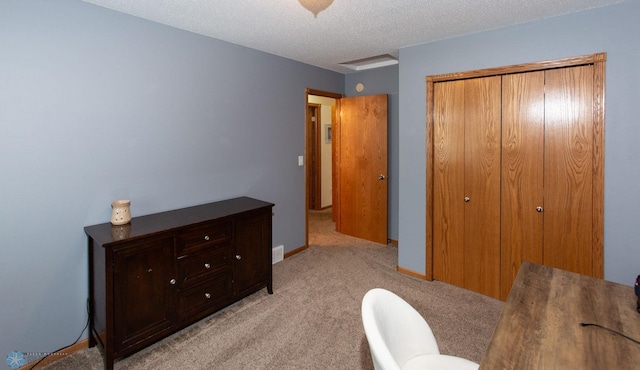 home office featuring light carpet and a textured ceiling