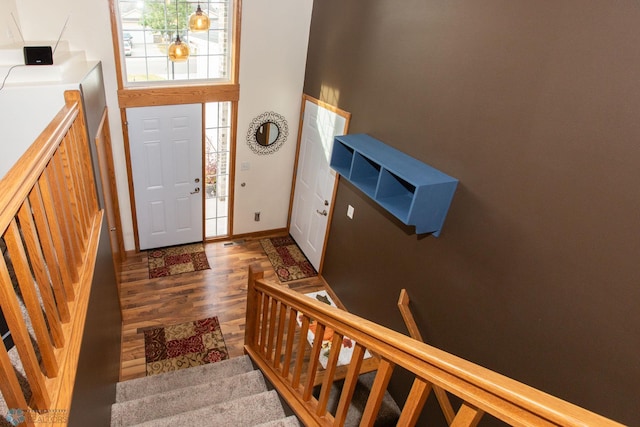 entryway featuring a high ceiling and dark hardwood / wood-style floors