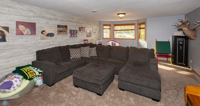 carpeted living room with wooden walls and a textured ceiling