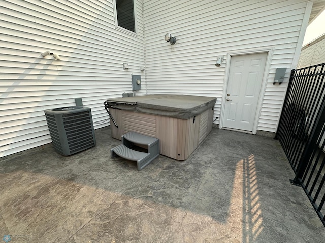 view of patio / terrace featuring a hot tub and cooling unit