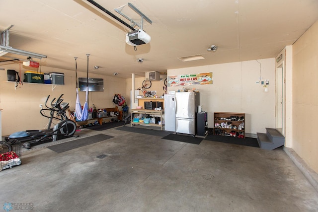 garage featuring a garage door opener and stainless steel fridge