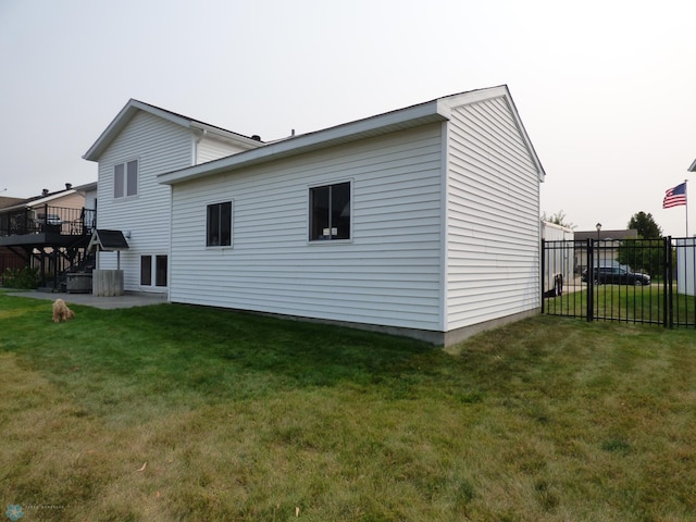 back of property featuring a lawn and a patio area