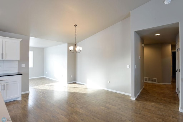 interior space featuring wood-type flooring and a notable chandelier