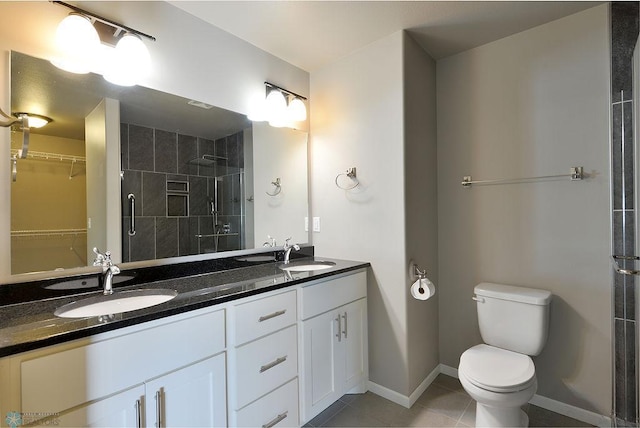 bathroom with tile patterned flooring, toilet, a shower with door, and vanity