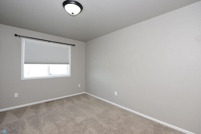 unfurnished room with light carpet