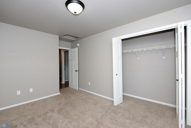 unfurnished bedroom with light carpet and a closet