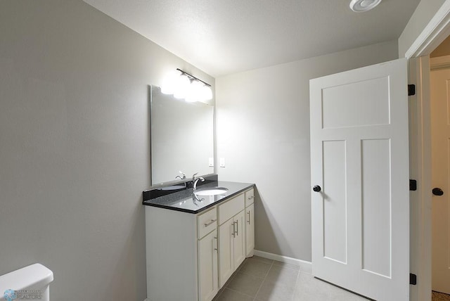 bathroom featuring vanity, toilet, and tile patterned floors