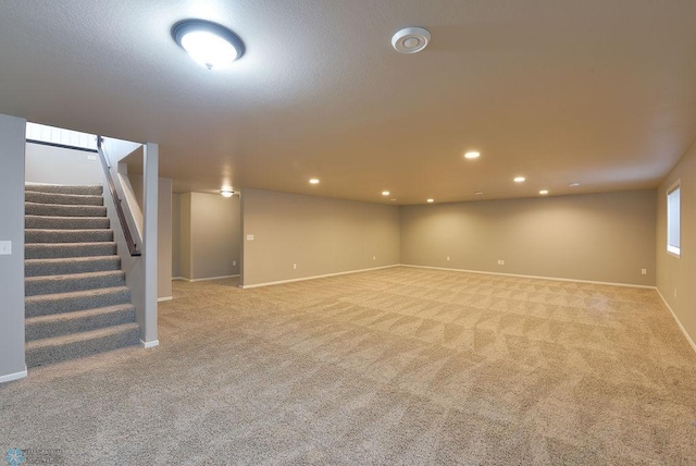 basement featuring light carpet