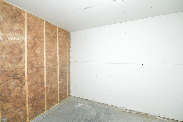 unfurnished room featuring concrete flooring