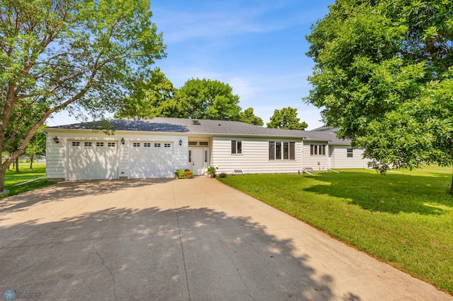 ranch-style house with a garage and a front lawn