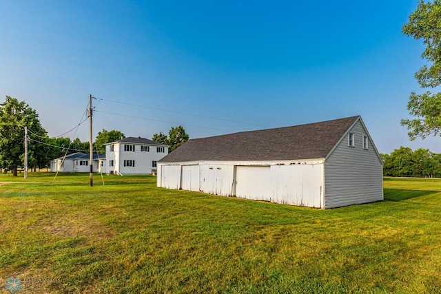 view of property exterior with a yard and an outbuilding