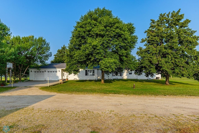 view of front of home featuring a garage and a front lawn