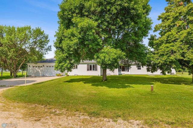 view of front of property featuring a garage and a front lawn