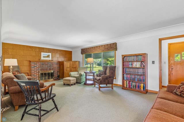 living room with a fireplace, ornamental molding, and carpet floors