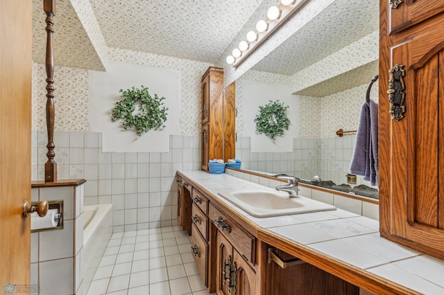 bathroom featuring a tub to relax in, vanity, tile walls, and tile patterned flooring