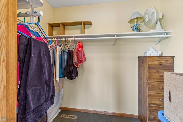 walk in closet with carpet floors