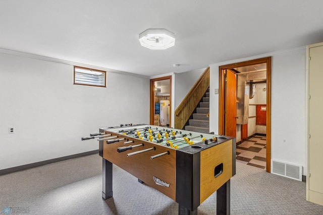 recreation room with crown molding and carpet flooring