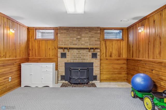 interior space with wood walls and a wood stove