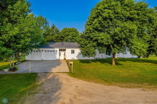 view of front of property featuring a garage and a front lawn