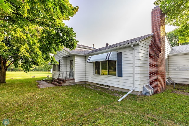 back of property with a lawn