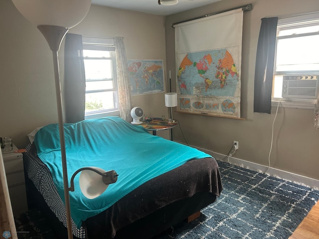 bedroom with hardwood / wood-style floors and cooling unit