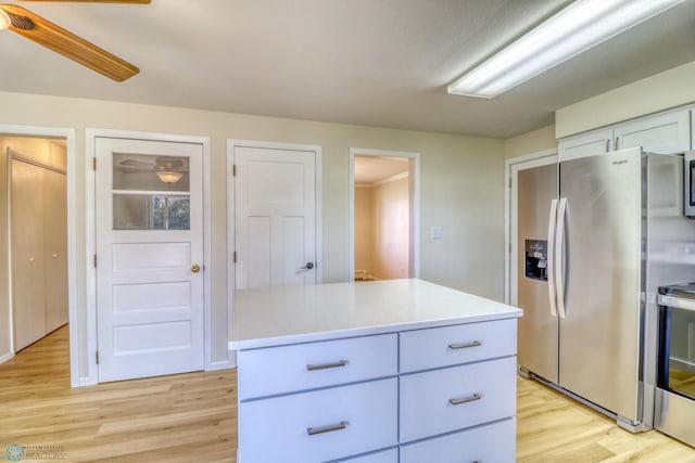 kitchen featuring light hardwood / wood-style flooring, white cabinetry, ceiling fan, and appliances with stainless steel finishes