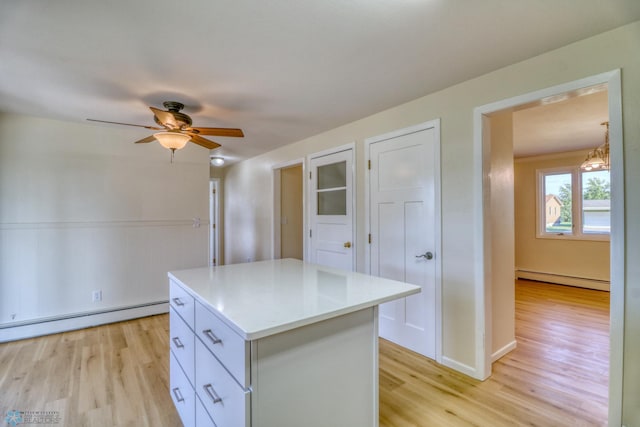 kitchen featuring white cabinetry, a center island, light hardwood / wood-style flooring, and a baseboard radiator