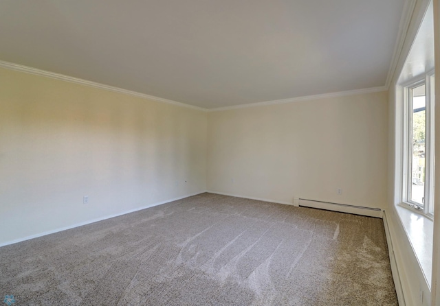 spare room featuring ornamental molding, baseboard heating, and carpet floors