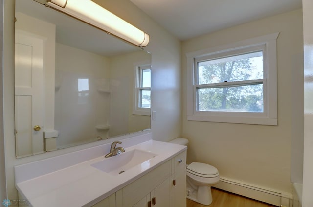 bathroom featuring baseboard heating, walk in shower, hardwood / wood-style floors, vanity, and toilet