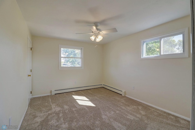 carpeted spare room featuring baseboard heating and ceiling fan