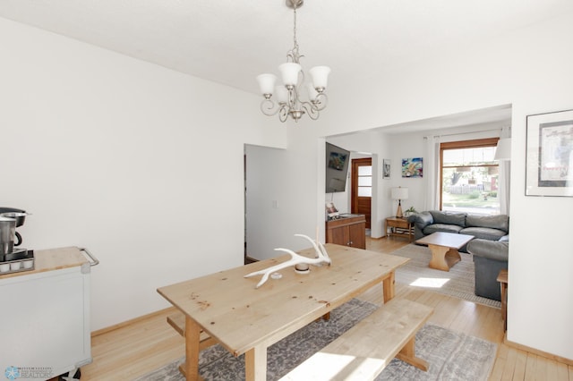 dining area with an inviting chandelier and light wood-type flooring