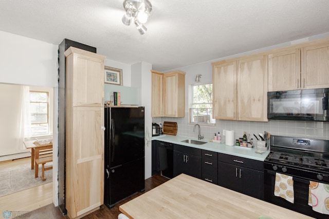 kitchen with dark hardwood / wood-style flooring, black appliances, light brown cabinetry, tasteful backsplash, and sink