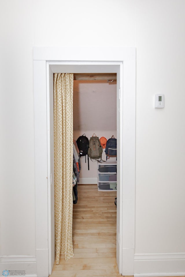 walk in closet featuring hardwood / wood-style flooring