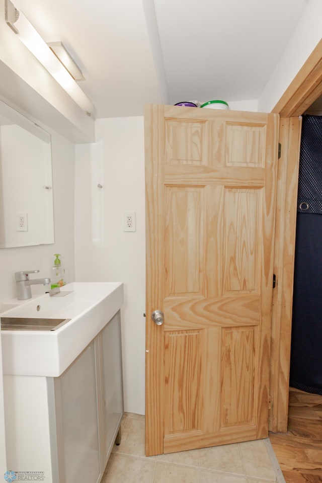 bathroom with tile patterned flooring and vanity