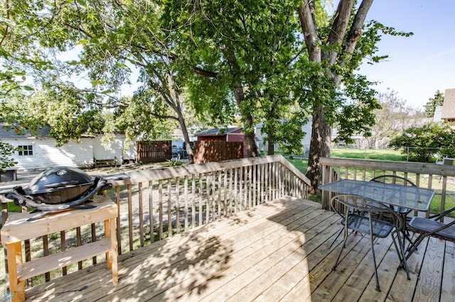 wooden deck featuring a storage shed