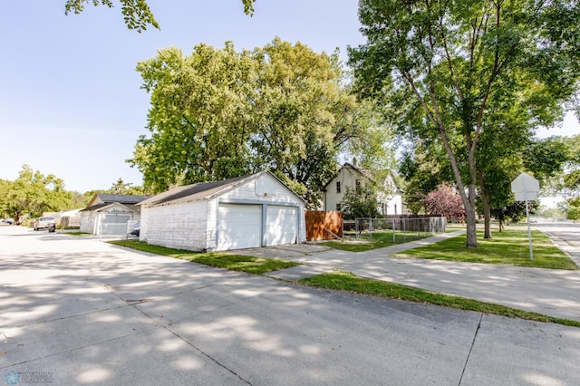 exterior space featuring a garage and an outbuilding