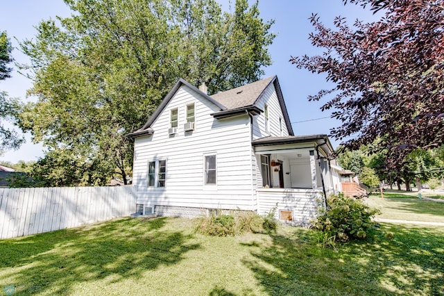 view of side of home featuring a lawn