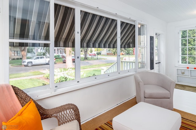 living area featuring a wealth of natural light and carpet