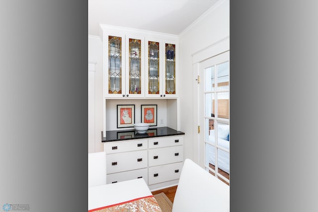 interior space featuring ornamental molding and hardwood / wood-style flooring