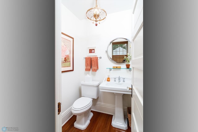 bathroom with toilet and hardwood / wood-style flooring