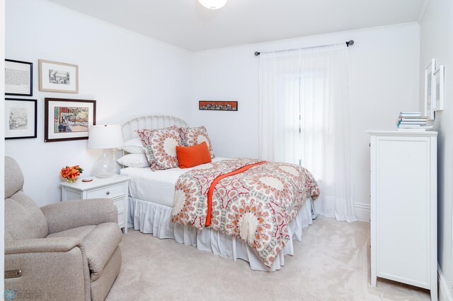 bedroom with light carpet and crown molding