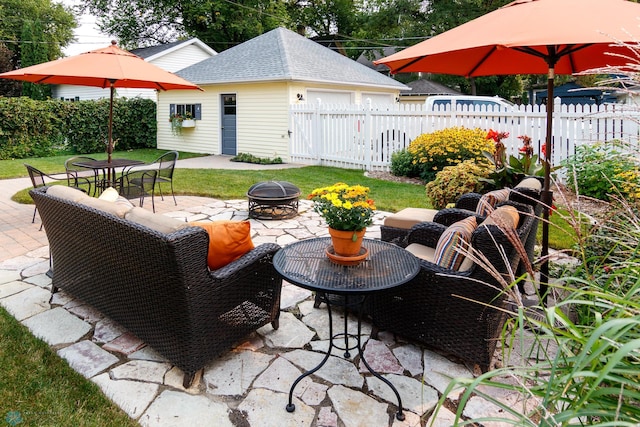 view of patio / terrace featuring an outdoor structure and a fire pit